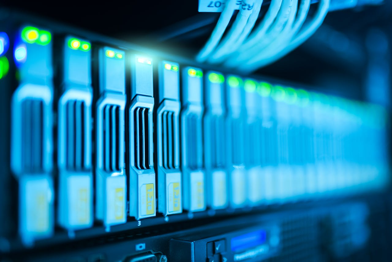 gallery-img-01 Detailed image of a server rack with glowing lights in a modern data center.