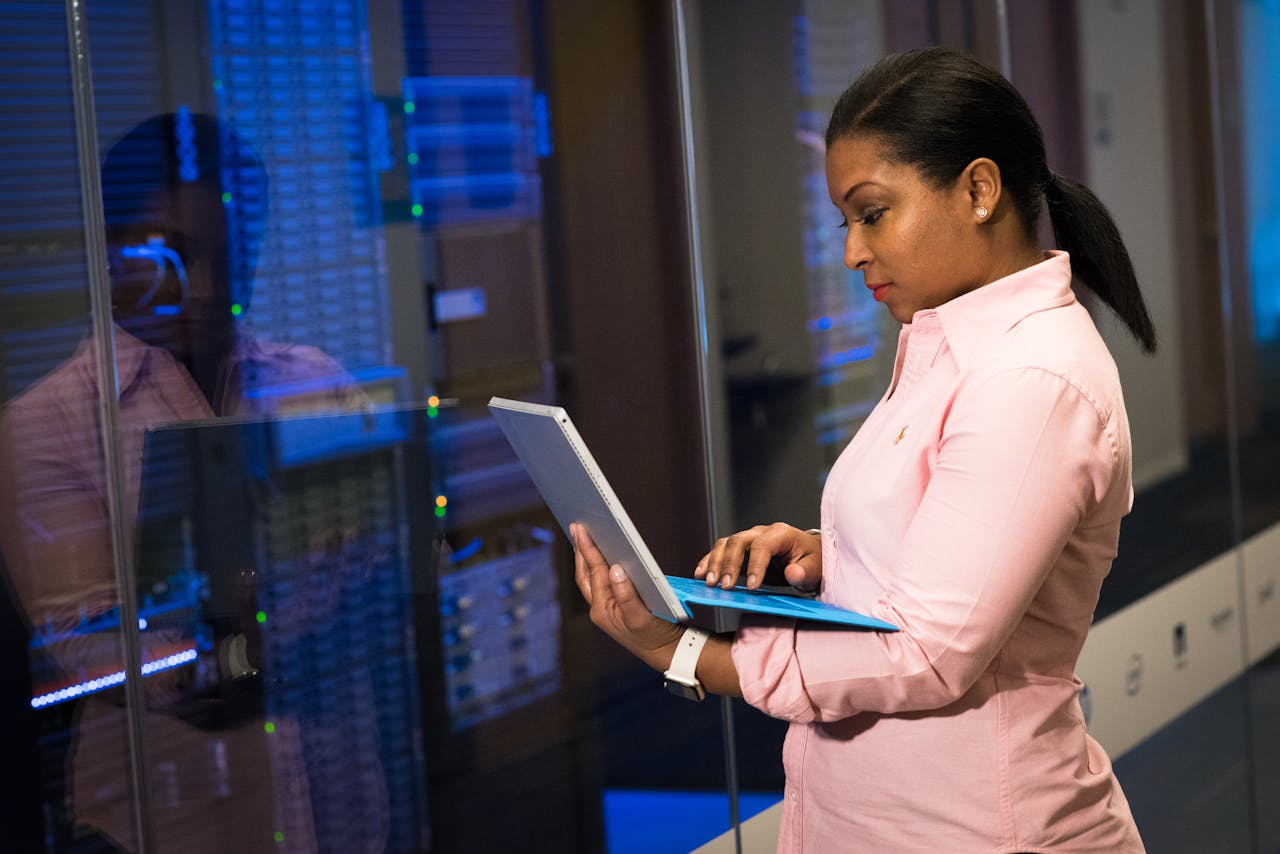 why-choose-us-img A focused software engineer working on a laptop in a server room, reflecting dedication in tech.