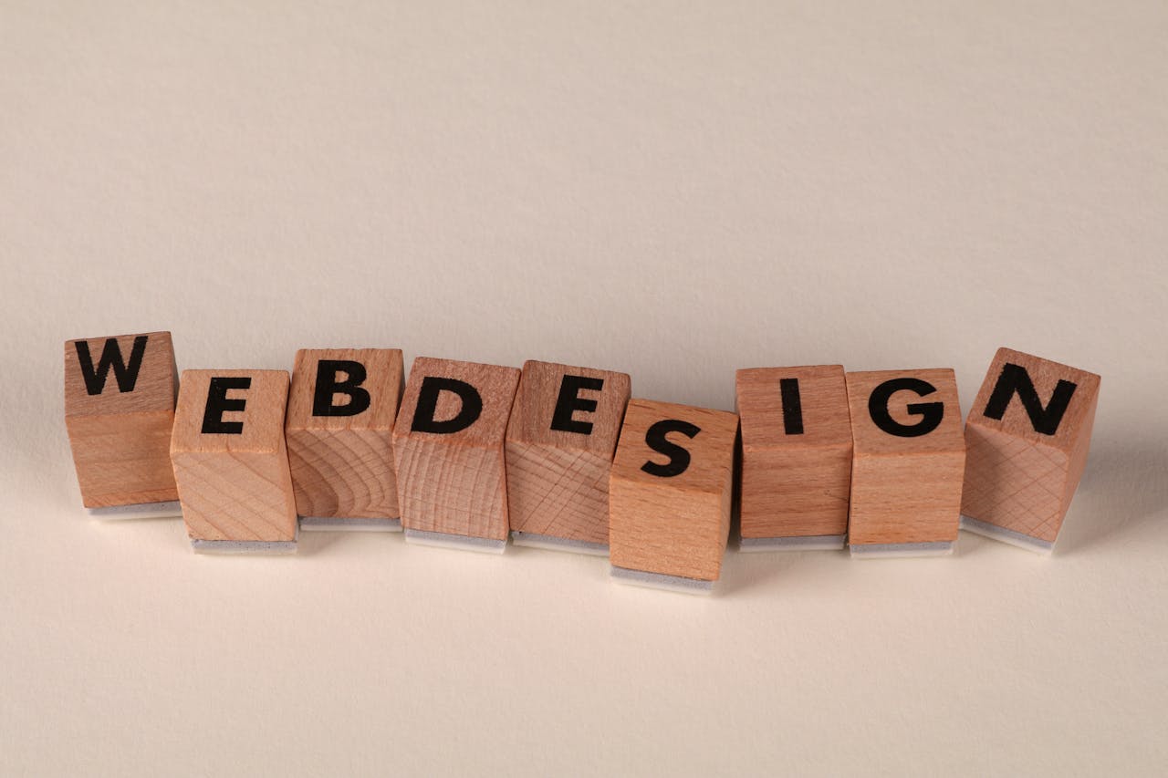 programs-03 Wooden blocks spelling 'web design' creatively showcase digital design concept.