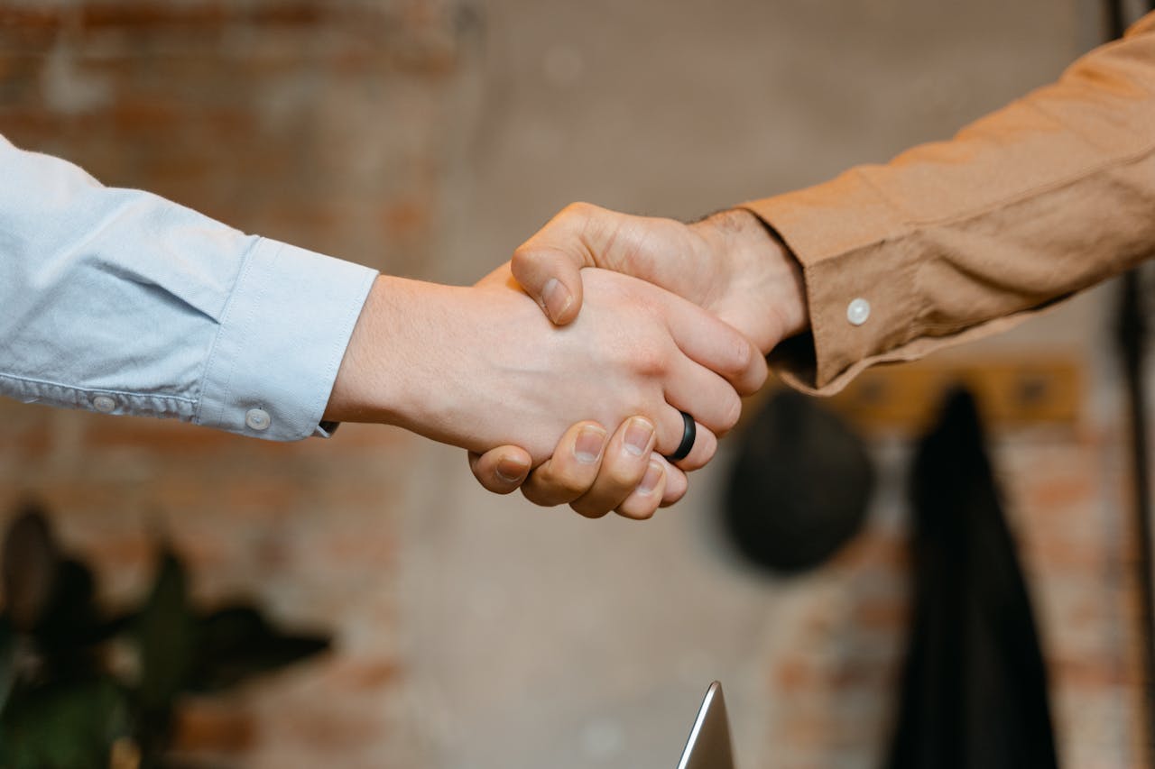 gallery-img-02 Close-up of a firm handshake symbolizing a business deal agreement.